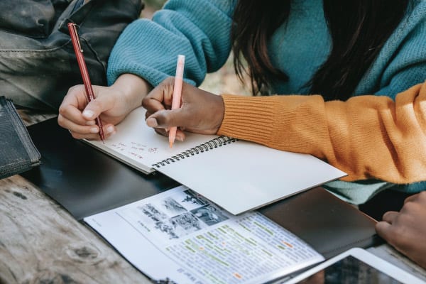 Two students studying with a book