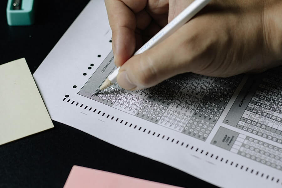 Close up shot of person taking a multiple choice test on paper